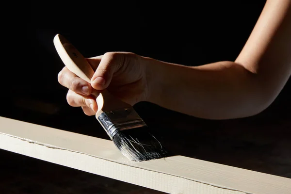Ręczne malowanie powierzchni naturalnego drewna deski w biały kolor na czarnym tle — Zdjęcie stockowe
