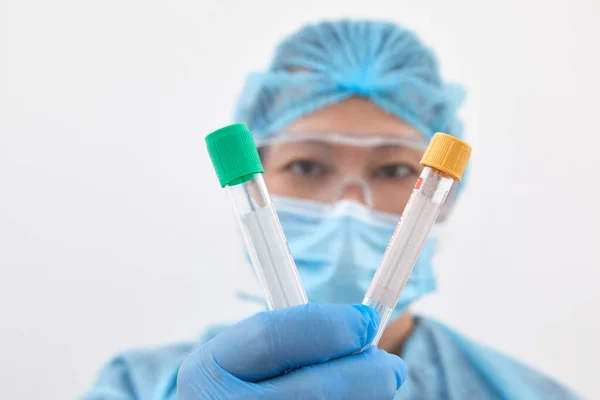 Kvinnlig forskare som håller två provrör i laboratorium för forskning och analys. Koncept för hälso- och sjukvård — Stockfoto