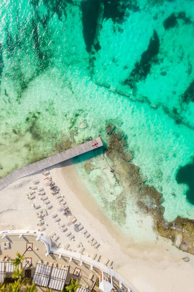 Aerial wysoki widok z góry kobiety leżącej na drewnianym molo w słoneczny letni dzień w Cancun, Meksyk, widok z góry. Młoda seksowna kobieta w czerwonym stroju kąpielowym w lecie na Karaibach. Letnia koncepcja wakacji na plaży — Zdjęcie stockowe