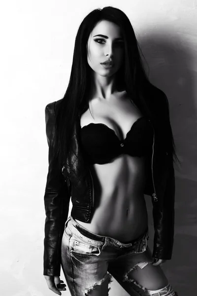 Sexy woman with dark hair wears lingerie and leather jacket — 스톡 사진