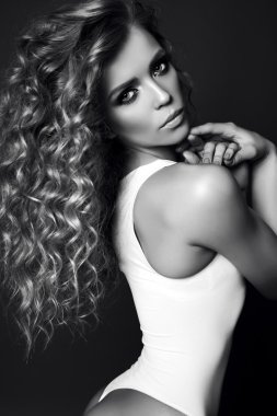 sexy beautiful girl with luxurious curly hair wears lingerie   