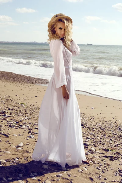 Gorgeous sexy woman with blond curly hair in elegant beach dress — Stock Photo, Image