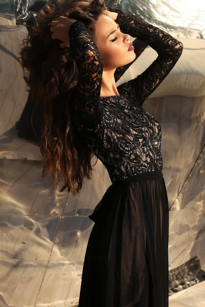Beautiful girl with dark hair in black lace dress — Stock Photo, Image
