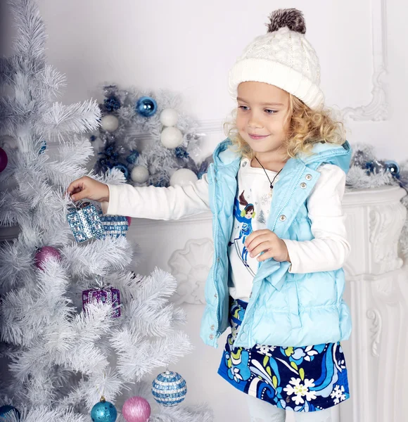 Cute little girl decorating Christmas tree — Stock Photo, Image