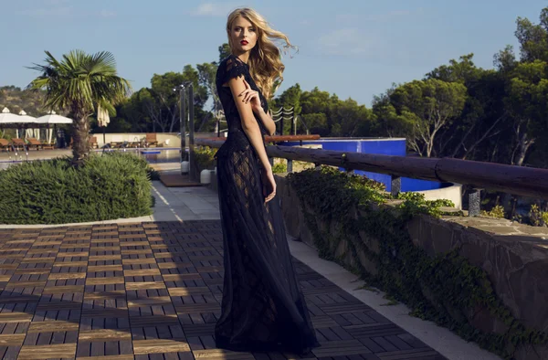 Bonita jovem mulher em vestido de luxo andando pelo parque — Fotografia de Stock