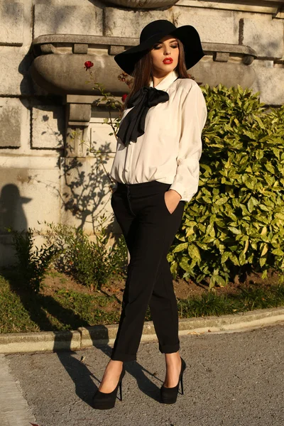 Beautiful ladylike woman wearing elegant blouse,pants and hat — Stock Photo, Image