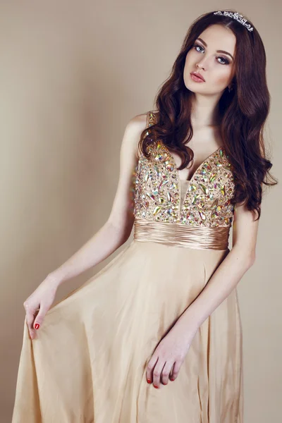 Beautiful girl with luxurious dark hair in sequin dress posing at studio — Stock Photo, Image