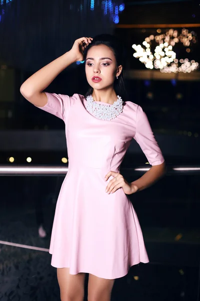 Beautiful young woman with dark hair wearing elegant dress — Stock Photo, Image