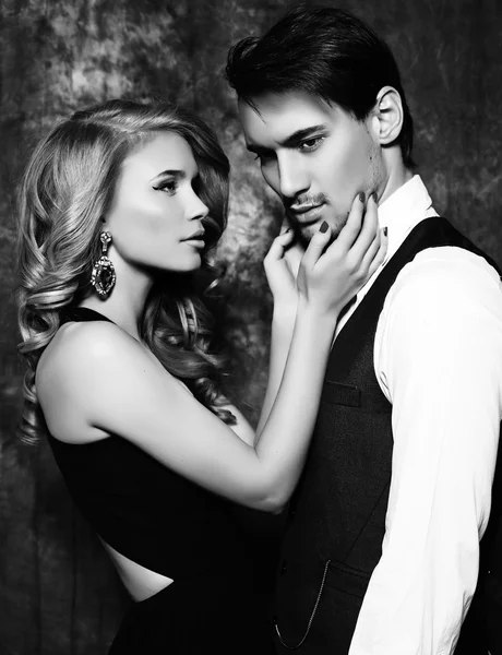 Beautiful sensual couple in elegant clothes posing in studio — Stock Photo, Image