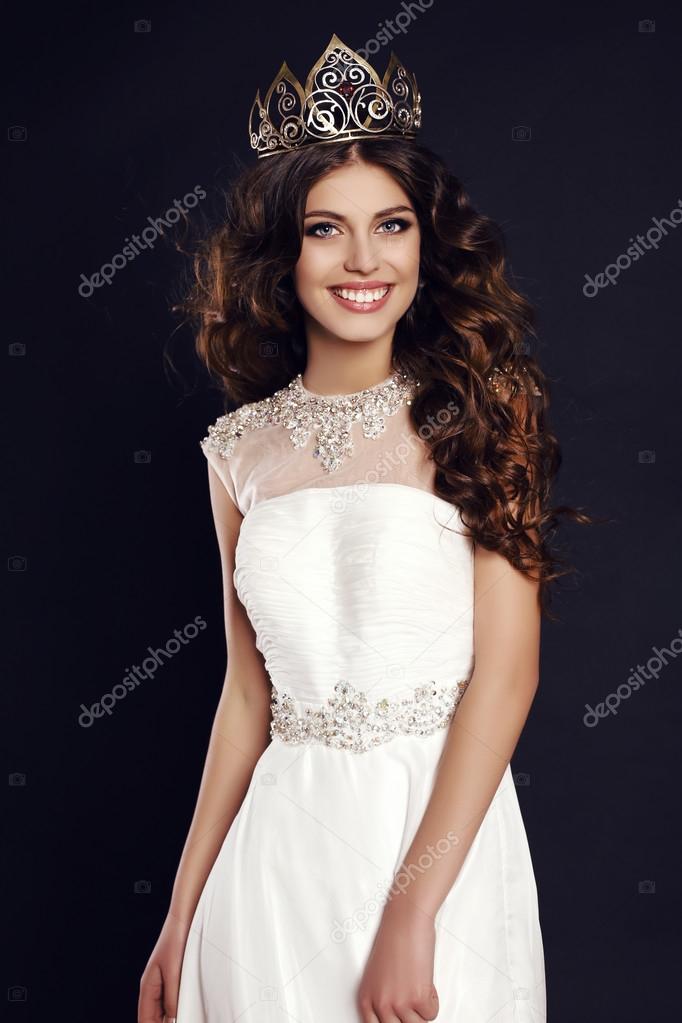 gorgeous young woman with luxurious hair wearing crown of beauty contest 