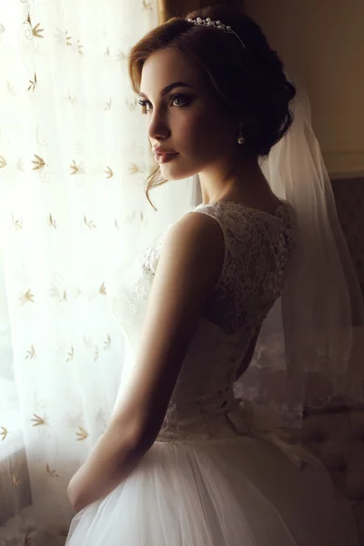 Pięknej narzeczonej zmysłowy z ciemnych włosów w luksusowych koronki sukni ślubnej — Zdjęcie stockowe