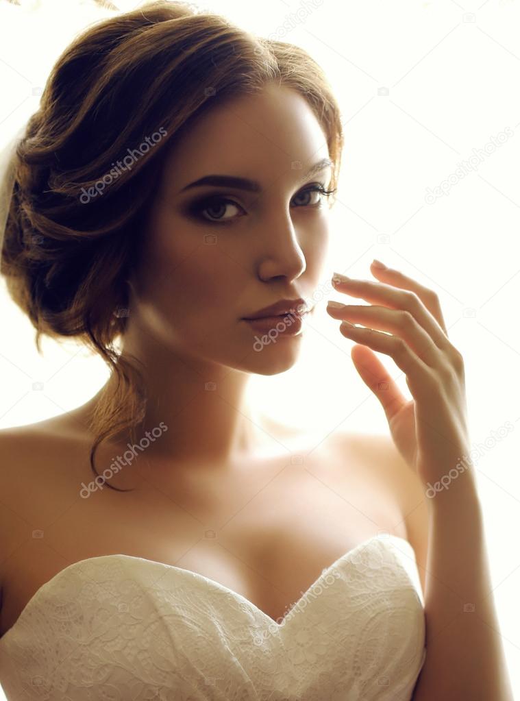 beautiful sensual bride with dark hair in luxurious lace wedding dress  