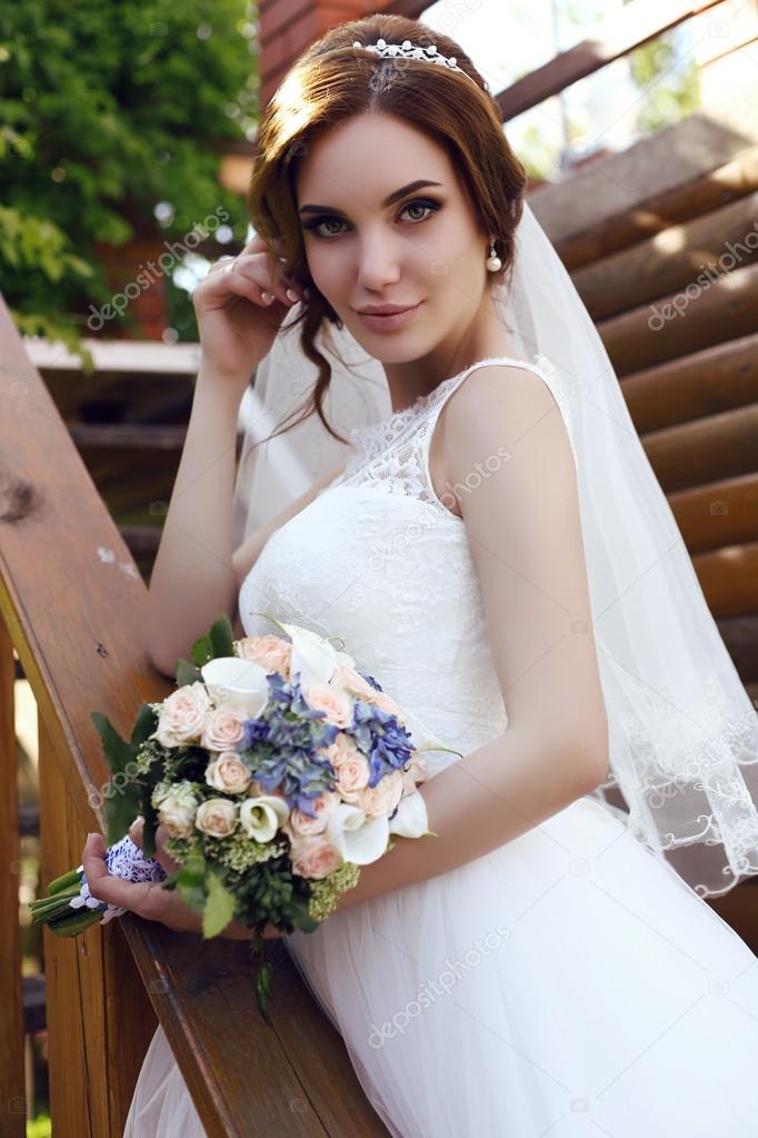 beautiful sensual bride with dark hair in luxurious  wedding dress 