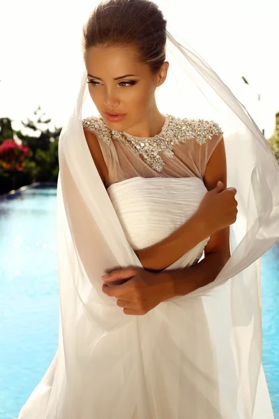 Beautiful sexy girl with blond hair in elegant wedding dress — Stock Photo, Image