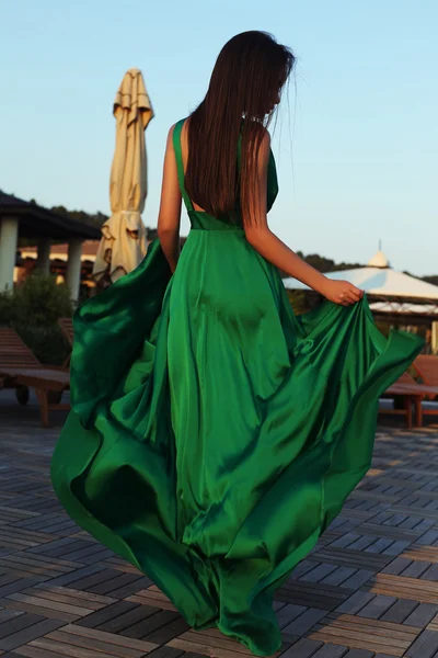 Sensual woman with dark hair in elegant silk dress — Stok fotoğraf