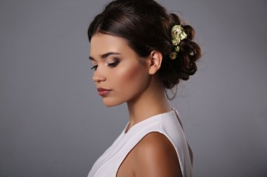 beautiful girl with evening makeup and elegant hairstyle