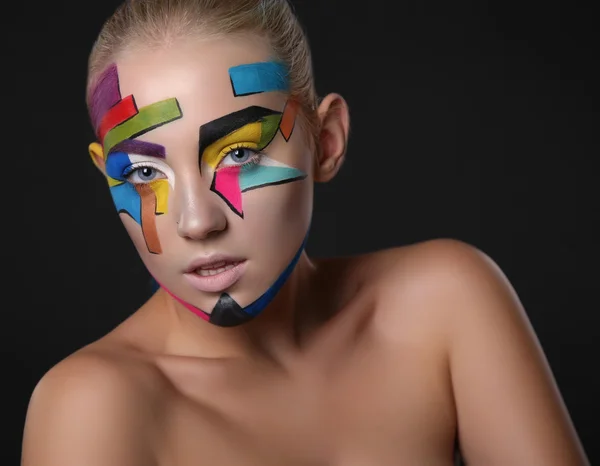 Young girl with bright geometric pattern on her face.Halloween style — Stockfoto