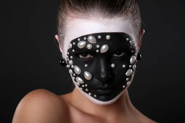 Girl with black and white art pattern on her face.Halloween style — Stockfoto