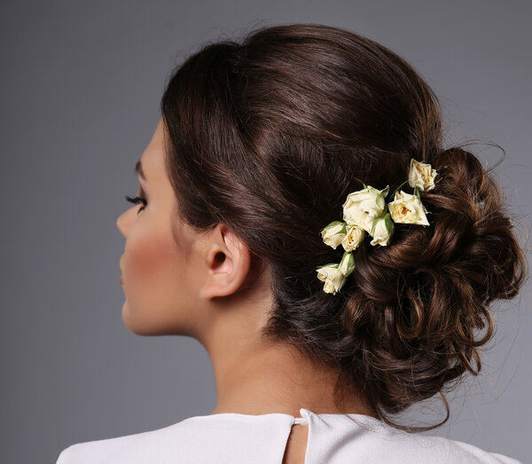 beautiful girl with evening makeup and elegant hairstyle