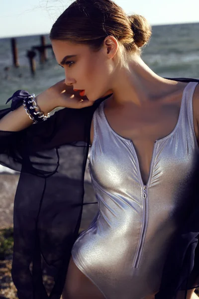 Sensual girl with blond hair wears luxurious silver swimsuit — Stock Photo, Image