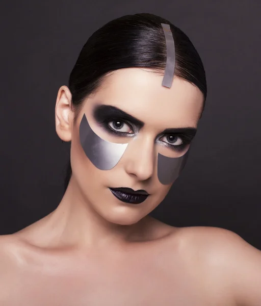 Woman with dark  hair and metallic extraordinary makeup — Stock Photo, Image