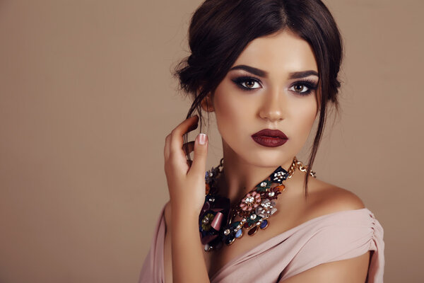 young woman with elegant hairstyle and luxurious necklace