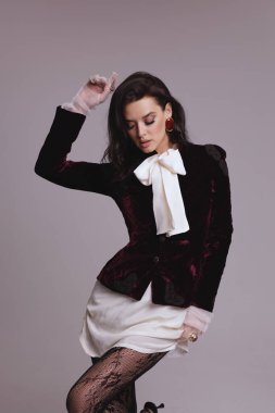 Güzel, seksi Slav bir kadının moda fotoğrafı. Koyu renk saçlı, lüks elbiseli, mücevherli.