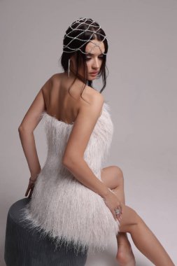 Güzel, siyah saçlı, takı ve saç aksesuarlarıyla süslü güzel bir Slav kadının moda fotoğrafı.