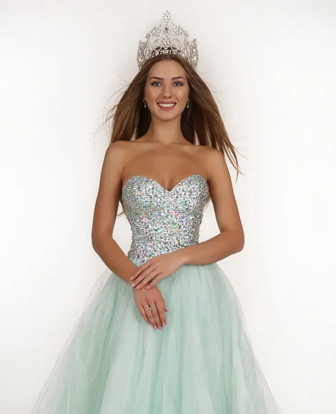 Beautiful girl with long hair wears luxurious dress and crown — Stock Fotó