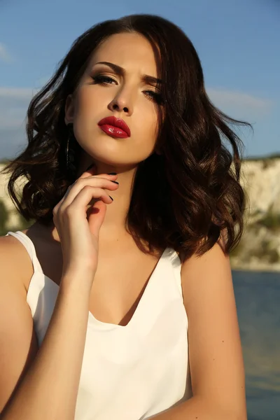 Beautiful woman with short dark hair wears elegant dress — Stock Photo, Image