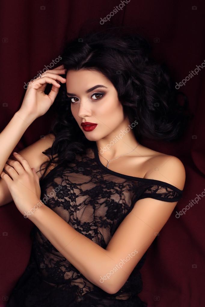 Premium Photo | A young pretty woman in a black dress with a slit on the  leg poses while standing in the studio confident attractive woman with  makeup and hairstyle