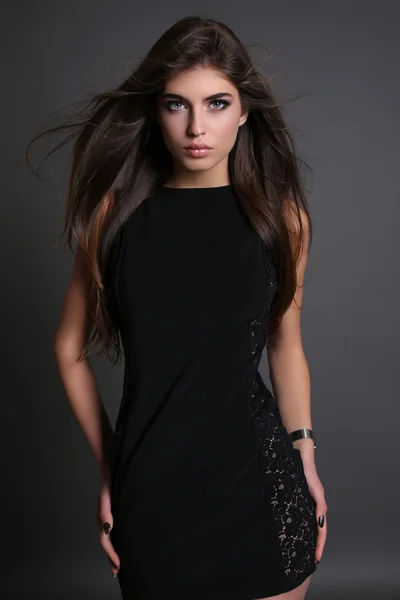 Gorgeous sensual woman with dark straight hair wears elegant dress — Stock Photo, Image