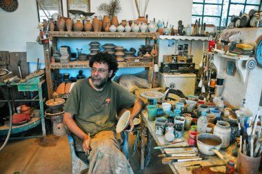 The potter in this workshop in Lefkes Paros Greece clipart