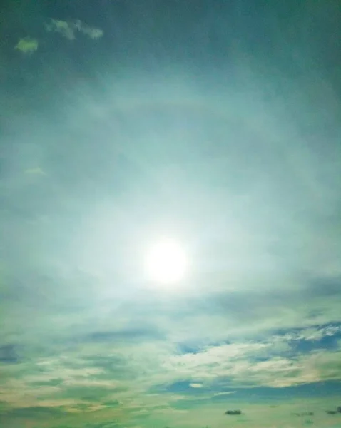 Brightly shining sun with halo around it