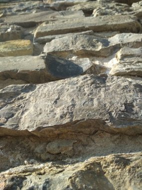 Fragment of ancient wall laid by Roman people of fossil rock 