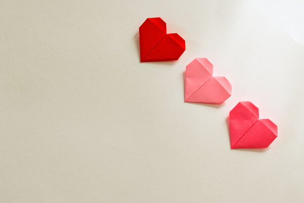Origami paper hearts on a white background