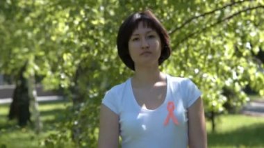Woman pinning orange awareness ribbon
