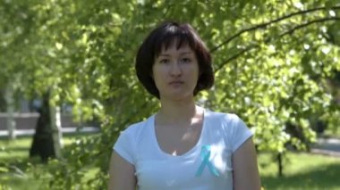 Young woman with teal awareness ribbon