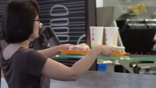 Woman getting order in McDonald — Stock Video