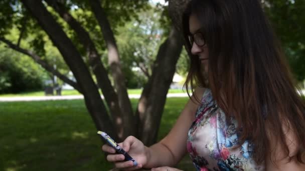 Jeune fille avec téléphone portable en plein air — Video