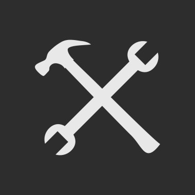 Crossed white tools on dark grey background clipart