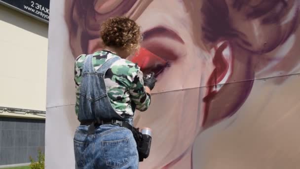 Vrouwelijke graffiti kunstenaar tekening een portret — Stockvideo