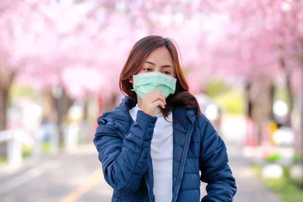 Corona virus in Japan portrait of a traveler young asian woman wearing surgical mask to protect from Corona virus(COVID-19). concept tourists travel in asia after the coronavirus epidemic.