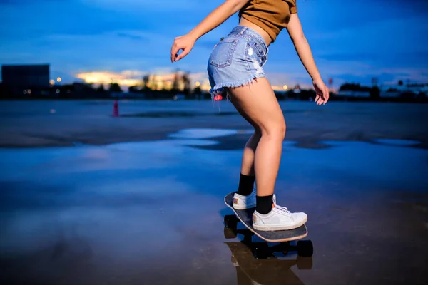 Close-up leg on surf skate or skates board outdoors on beautiful summer day. Sport activity lifestyle concept, Healthy and exercise.