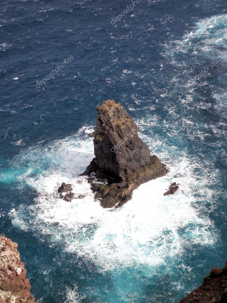Waves crushing into the rocks at sea