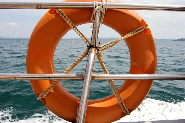 Lifebuoy attached to boat in blue sea — Stock Photo, Image