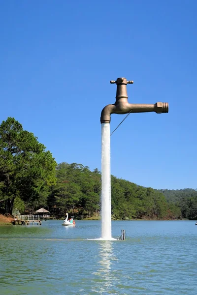 Free standing faucet floating over a lake — Stock Photo, Image