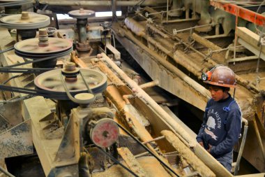 Kid miner at metals and precious metals ore enrichment plant in Potosi, Bolivia