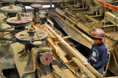 Kid miner at metals and precious metals ore enrichment plant in Potosi, Bolivia clipart