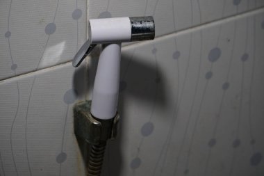 handheld bidet sprayer, also known as a shattaf or health faucet. Concept of the hygiene and cleanliness